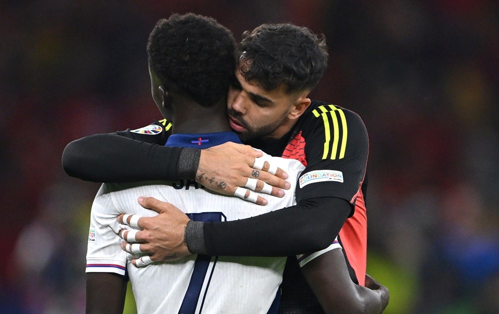 BERLIN, GERMANY: England player Bukayo Saka is consoled by David Raya of Spain after the UEFA EURO 2024 final match between Spain and England at Olympiastadion on July 14, 2024. (Photo by Stu Forster/Getty Images)