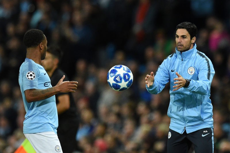 Manchester City assistant coach Mikel Arteta (R) tosses the ball to Manchester City's English midfielder Raheem Sterling during the UEFA Champions ...