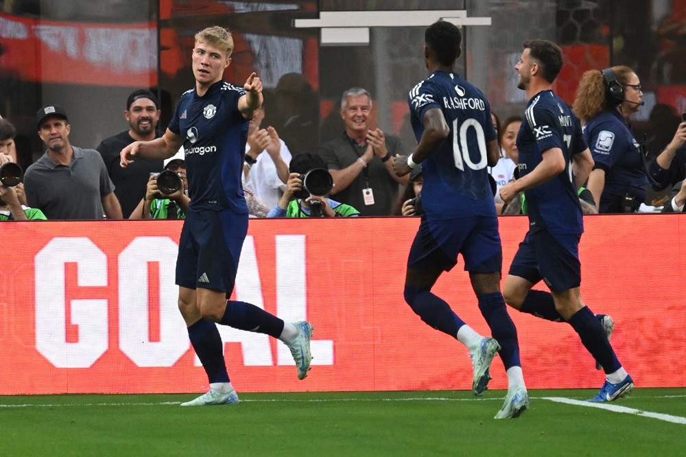 Manchester United's Rasmus Hojlund (L) reacts after scoring a goal during the pre-season club friendly football match between Manchester United FC ...