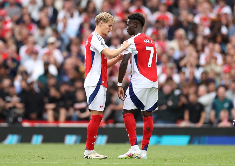 LONDON, ENGLAND - AUGUST 31: Martin Odegaard of Arsenal hands the Captains armband to Bukayo Saka of Arsenal during the Premier League match betwee...