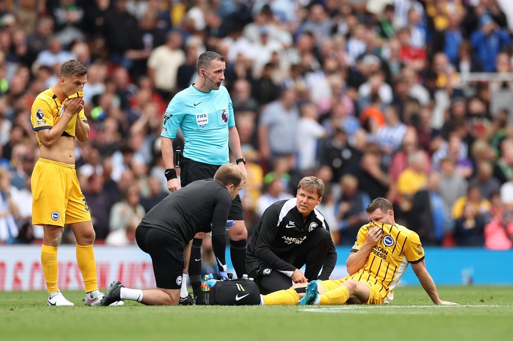 LONDON, ENGLAND: James Milner of Brighton & Hove Albion receives medical treatment before being substituted off due to injury during the Premier Le...