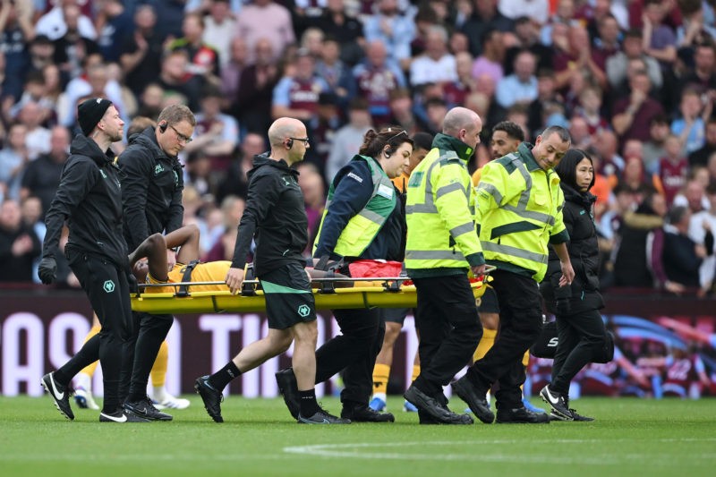 BIRMINGHAM, ENGLAND - SEPTEMBER 21: Yerson Mosquera of Wolverhampton Wanderers receives medical treatment during the Premier League match between A...