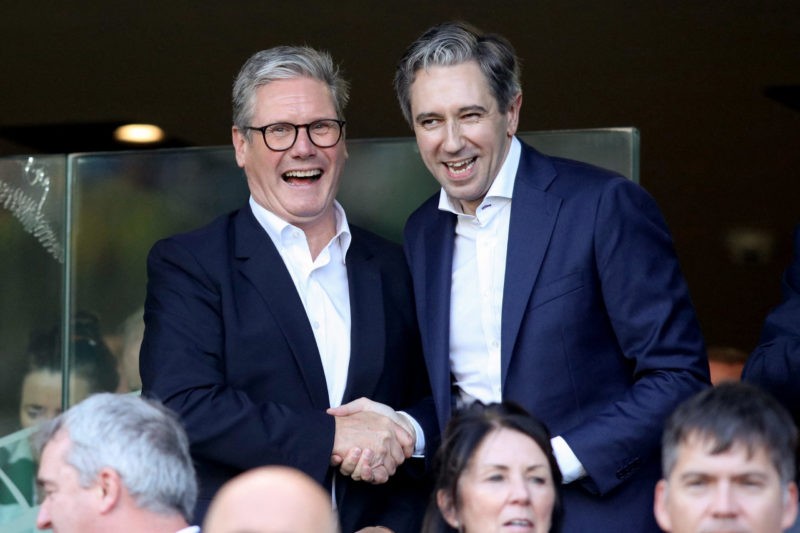 Ireland's Prime Minister Simon Harris (R) and Britain's Prime Minister Keir Starmer react in the stands during the UEFA Nations League, League B, g...