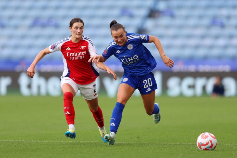 LEICESTER, ENGLAND - SEPTEMBER 29: Missy Goodwin of Leicester City runs with the ball under pressure from Emily Fox of Arsenal during the Barclays ...