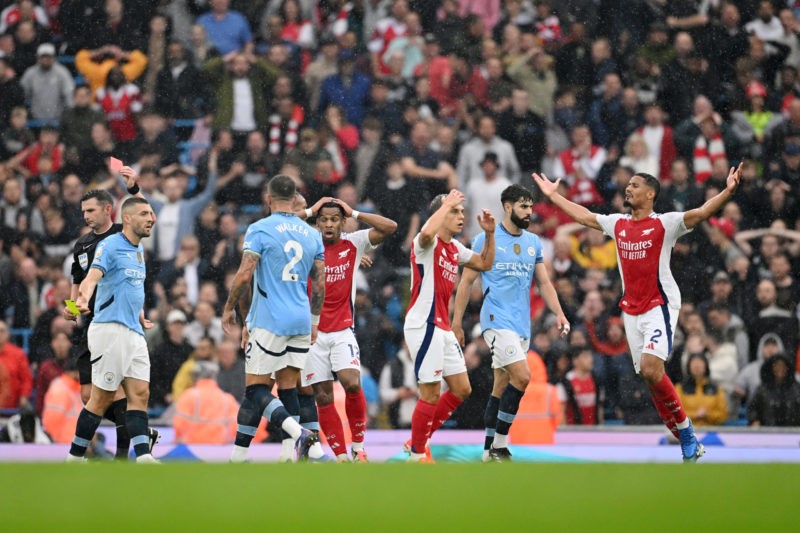 PGMOL confirm absurd reason for Arsenal sub booking 4 MANCHESTER, ENGLAND - SEPTEMBER 22: Players react as Referee, Michael Oliver shows a red card to Leandro Trossard of Arsenal during the Premier League match between Manchester City FC and Arsenal FC at Etihad Stadium on September 22, 2024 in Manchester, England. (Photo by Michael Regan/Getty Images)