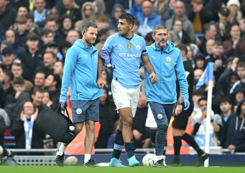 MANCHESTER, ENGLAND - SEPTEMBER 22: Rodri of Manchester City leaves the pitch following an injury during the Premier League match between Mancheste...