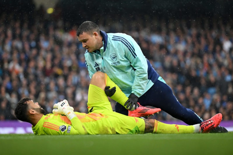 MANCHESTER, ENGLAND - SEPTEMBER 22: David Raya of Arsenal receives medical treatment during the Premier League match between Manchester City FC and...