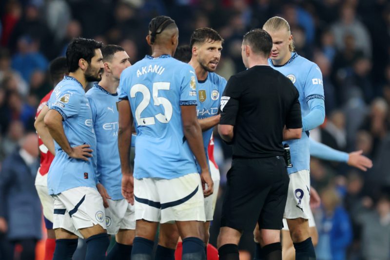 MANCHESTER, ENGLAND - SEPTEMBER 22: Ruben Dias reacts towards Referee, Michael Oliver during the Premier League match between Manchester City FC an...