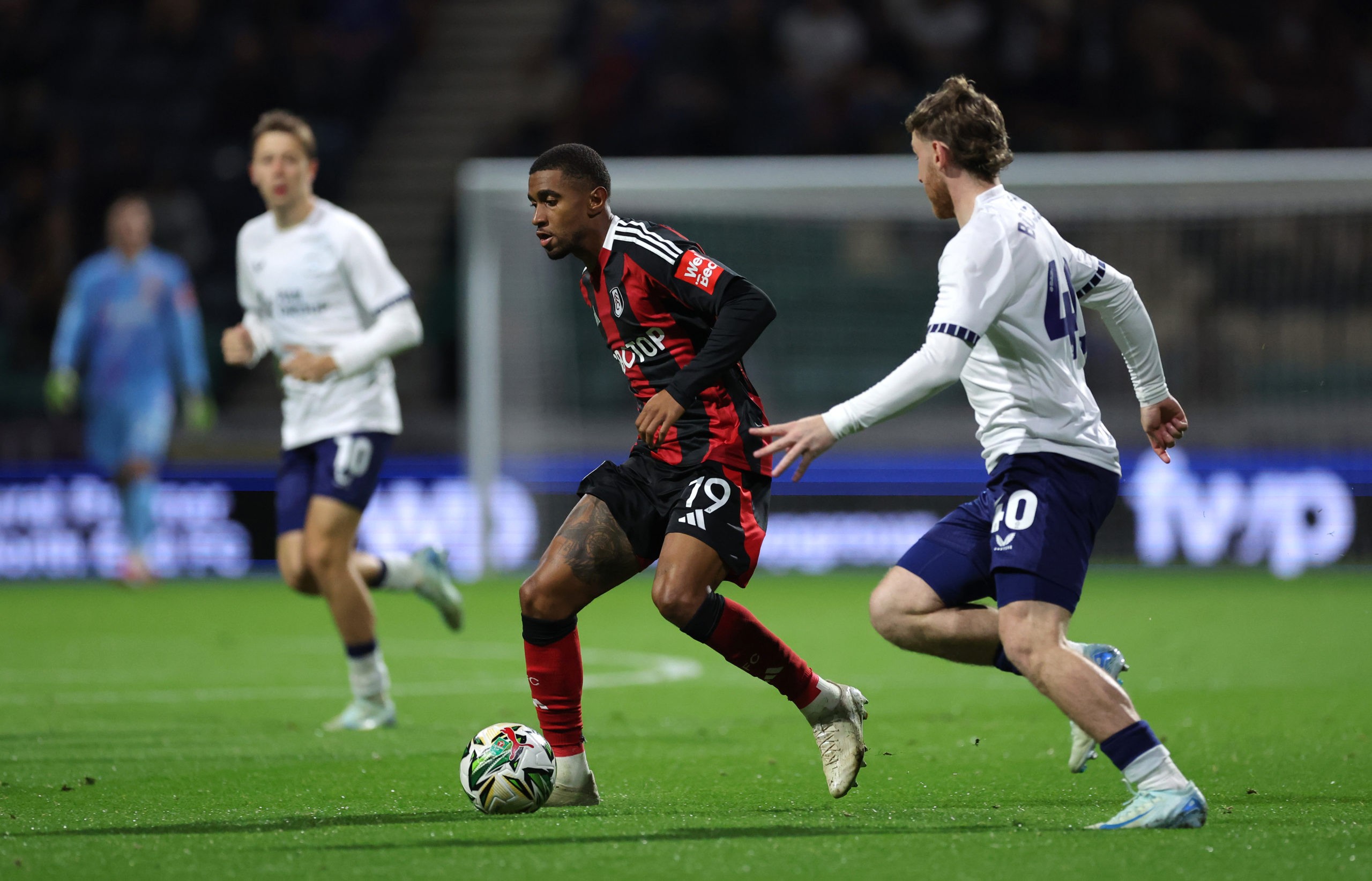 PRESTON, ENGLAND: Reiss Nelson of Fulham is put under pressure by Josh Bowler of Preston North End during the Carabao Cup Third Round match between...
