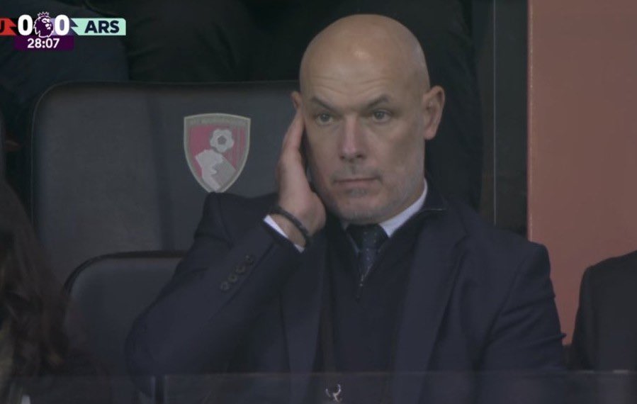 Howard Webb listens to an earpiece during Arsenal's match against Bournemouth (Image via Sky Sports)