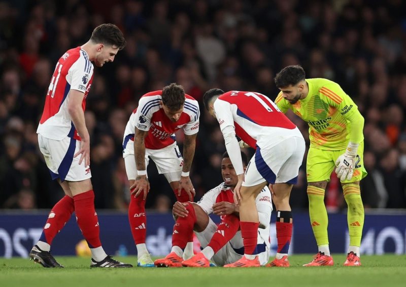 LONDON, ENGLAND: Gabriel of Arsenal reacts as he is checked on by team mates before receiving medial treatment for an injury during the Premier Lea...