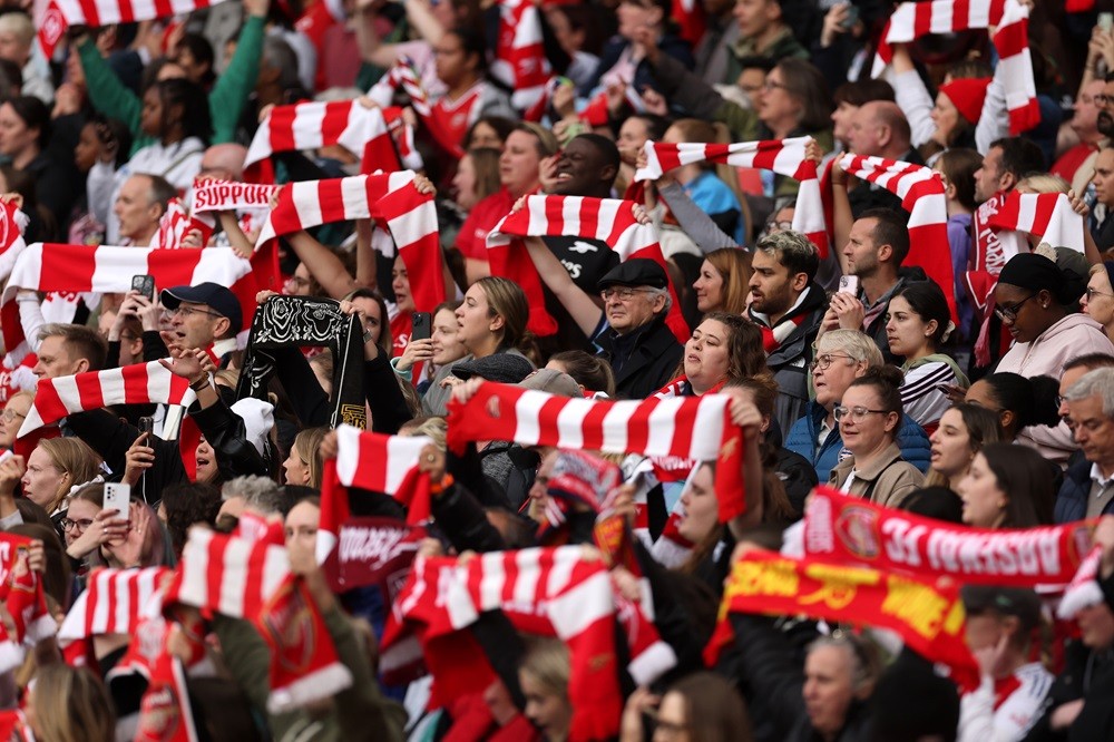 LONDON, ENGLAND: Arsenal fans hold scarfs aloft during the Barclays Women's Super League match between Arsenal and Chelsea at Emirates Stadium on O...