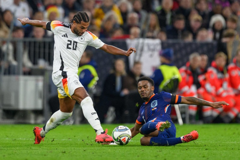 MUNICH, GERMANY - OCTOBER 14: Serge Gnabry of Germany challenges Jorrel Hato of Netherlands during the UEFA Nations League 2024/25 League A Group A3 match between Germany and Netherlands at on October 14, 2024 in Munich, Germany. (Photo by Christian Kaspar-Bartke/Getty Images for DFB)
