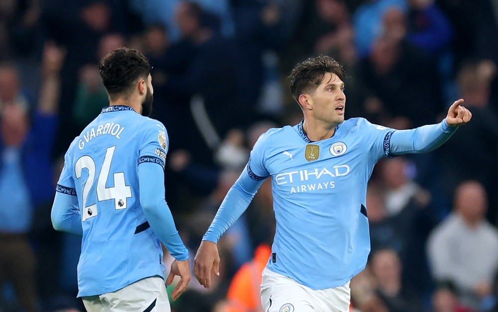 MANCHESTER, ENGLAND: John Stones of Manchester City celebrates scoring his team's second goal during the Premier League match between Manchester Ci...