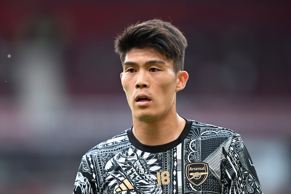 MANCHESTER, ENGLAND: Takehiro Tomiyasu of Arsenal looks on as he warms up prior to the Premier League match between Manchester United and Arsenal F...