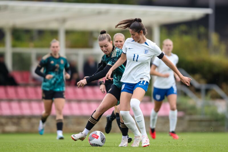 BURTON-UPON-TRENT, ENGLAND - SEPTEMBER 26: Alara Sehitler of Germany is challenged by Freya Godfrey of England during the international friendly ma...