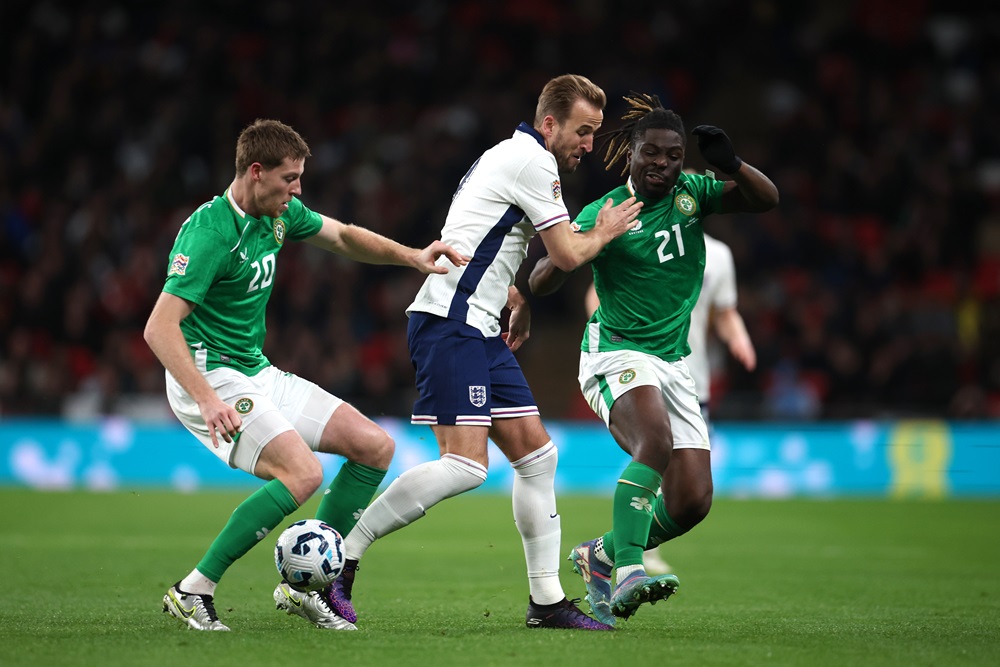 Former Arsenal youth makes senior international debut 2 LONDON, ENGLAND: Harry Kane of England is tackled by Festy Ebosele and Mark McGuinness of Ireland during the UEFA Nations League 2024/25 League B Group B2 match between England and Republic of Ireland at Wembley Stadium on November 17, 2024. (Photo by Alex Pantling/Getty Images)