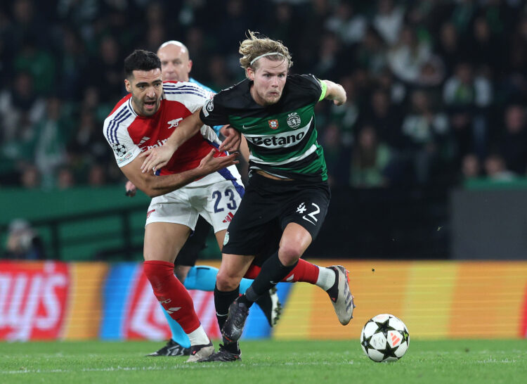 LISBON, PORTUGAL - NOVEMBER 26: Morten Hjulmand of Sporting CP runs with the ball whilst under pressure from Mikel Merino of Arsenal during the UEF...