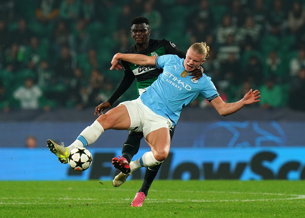 LISBON, PORTUGAL: Erling Haaland of Manchester City is tackled by Ousmane Diomande of Sporting CP during the UEFA Champions League 2024/25 League Phase MD4 match between Sporting Clube de Portugal and Manchester City at Estadio Jose Alvalade on November 05, 2024. (Photo by Gualter Fatia/Getty Images)