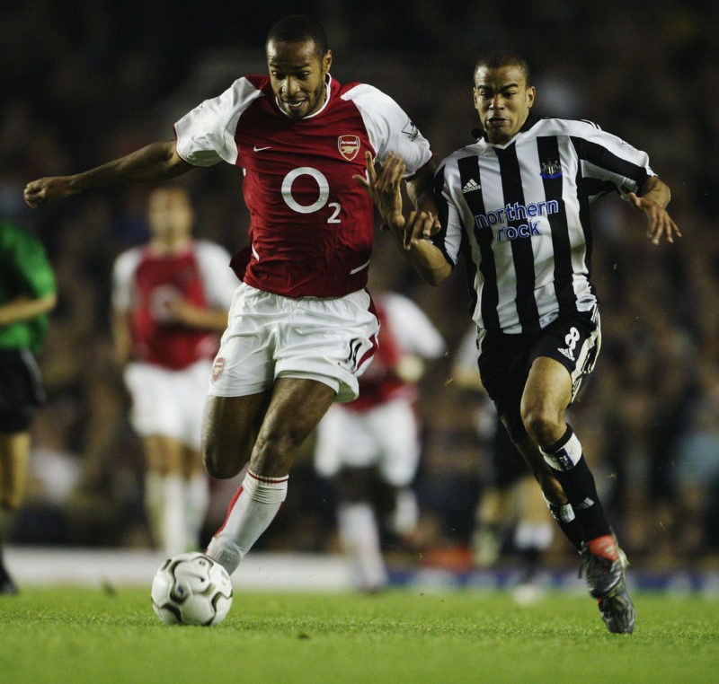 LONDON - SEPTEMBER 26: Thierry Henry of Arsenal holds off a challenge from Kieron Dyer of Newcastle United during the FA Barclaycard Premiership ma...