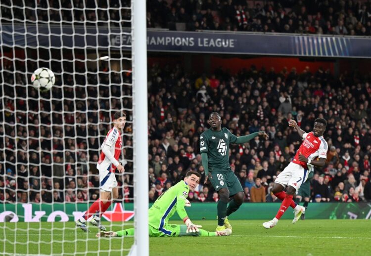 LONDON, ENGLAND: Bukayo Saka of Arsenal scores his team's second goal whilst under pressure from Mohammed Salisu of AS Monaco as Radoslaw Majecki o...