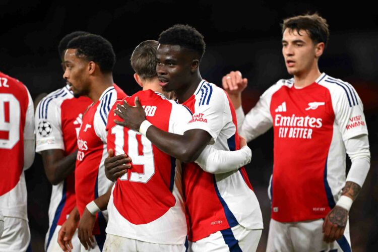 LONDON, ENGLAND - DECEMBER 11: Bukayo Saka of Arsenal celebrates scoring his team's second goal with teammate Leandro Trossard during the UEFA Cham...