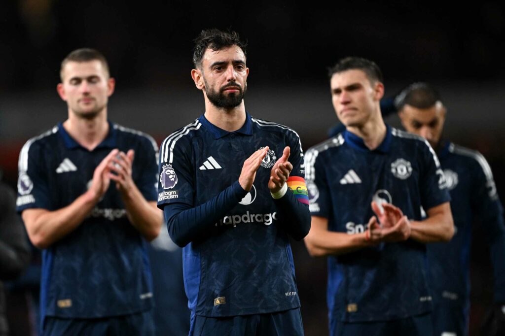 LONDON, ENGLAND - DECEMBER 04: Bruno Fernandes of Manchester United applauds the fans, whilst wearing a rainbow coloured captains armband, after defeat to Arsenal during the Premier League match between Arsenal FC and Manchester United FC at Emirates Stadium on December 04, 2024 in London, England. (Photo by Shaun Botterill/Getty Images)