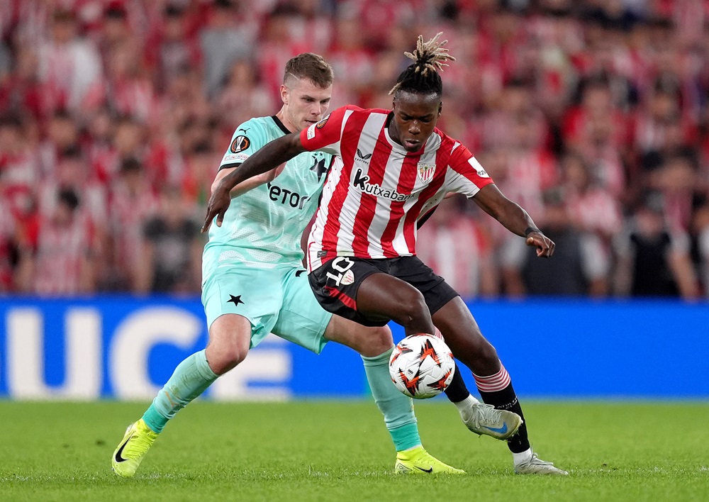 BILBAO, SPAIN: Nico Williams of Athletic Club controls the ball whilst under pressure from David Doudera of SK Slavia Praha during the UEFA Europa ...