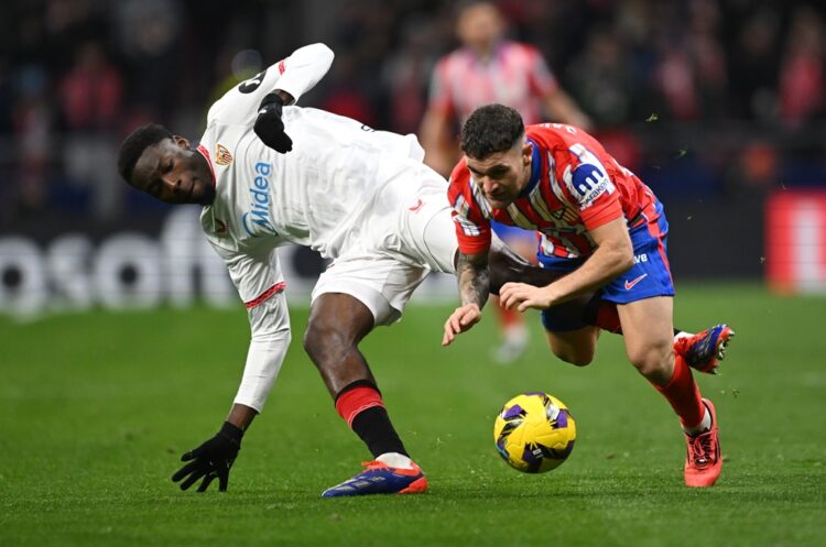 MADRID, SPAIN: Javi Galan of Atletico de Madrid (R) is fouled by Lucien Agoume of Sevilla FC during the LaLiga match between Atletico de Madrid and...
