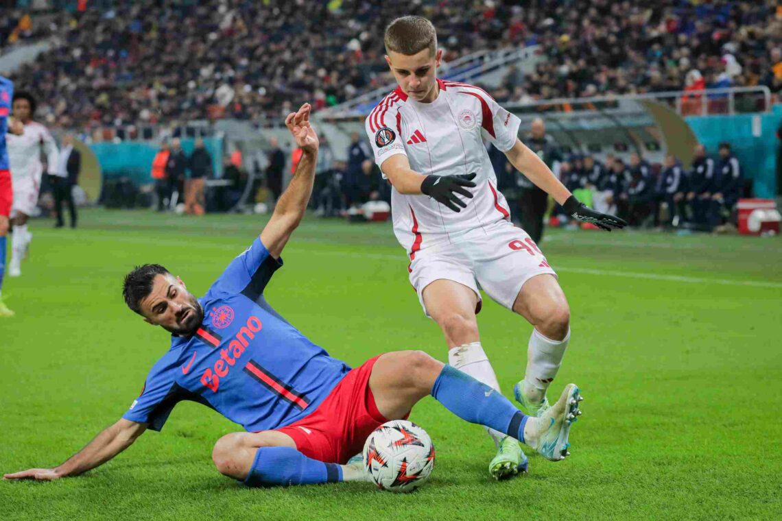BUCHAREST, ROMANIA - NOVEMBER 28: Valentin Cretu (L) of FCSB battles for the ball with Christos Mouzakitis (R) of Olympiacos during the UEFA Europa...