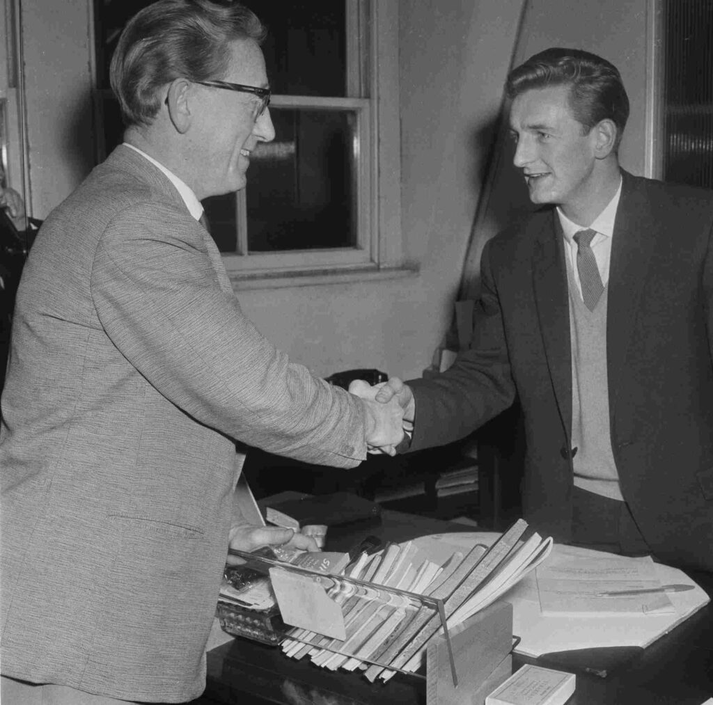 British soccer player George Eastham shaking hands with sport journalist and editor Bob Findlay, after signing for Arsenal FC, 18th November 1960. (Photo by Norman Potter/Daily Express/Getty Images)