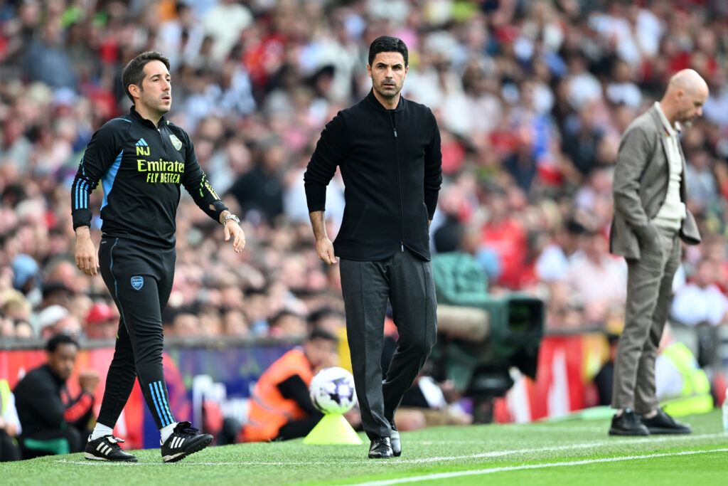 MANCHESTER, ENGLAND - MAY 12: Nicolas Jover, Coach of Arsenal, and Mikel Arteta, Manager of Arsenal, look on during the Premier League match between Manchester United and Arsenal FC at Old Trafford on May 12, 2024 in Manchester, England. (Photo by Michael Regan/Getty Images)