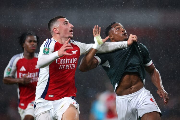 LONDON, ENGLAND: Maldini Kacurri of Arsenal grabs the shirt of Victor Adeboyejo of Bolton Wanderers during the Carabao Cup Third Round match betwee...