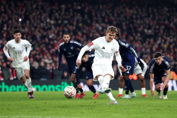 LONDON, ENGLAND: Martin Odegaard of Arsenal shoots from the penalty spot, which is saved by Altay Bayindir of Manchester United (not pictured) duri...