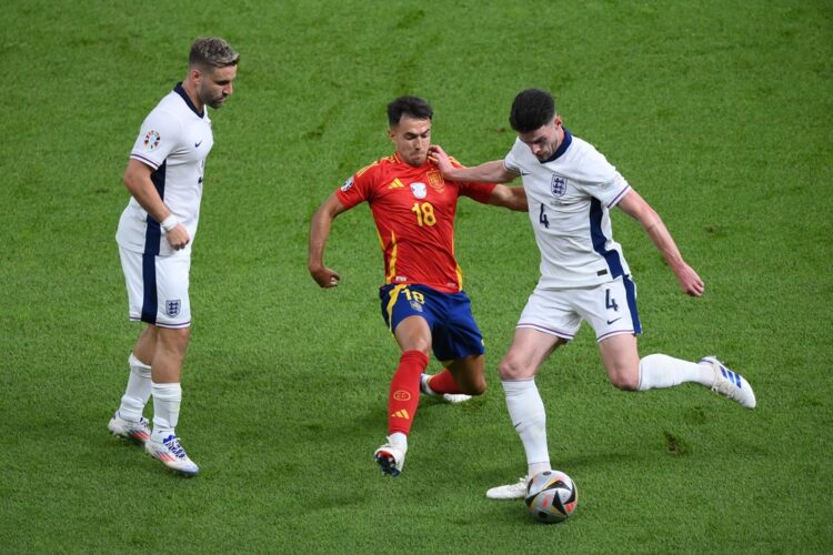 BERLIN, GERMANY: Declan Rice of England holds off Martin Zubimendi of Spain during the UEFA EURO 2024 final match between Spain and England at Olym...