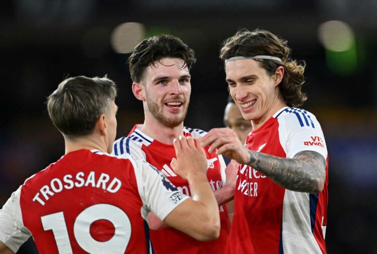 WOLVERHAMPTON, ENGLAND - JANUARY 25: Declan Rice, Riccardo Calafiori and Leandro Trossard of Arsenal celebrate victory following the Premier League...