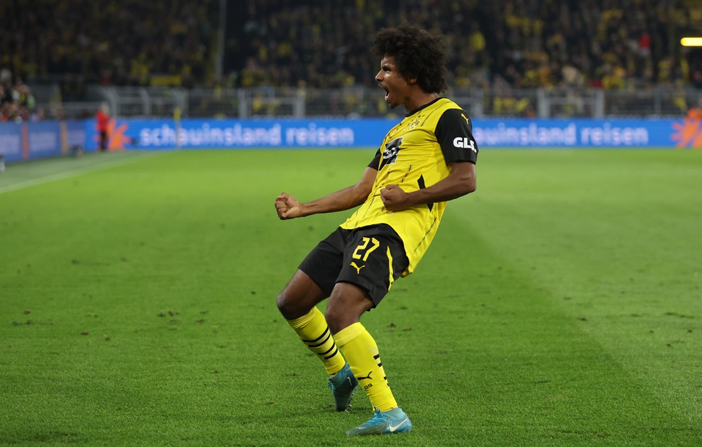 DORTMUND, GERMANY: Karim Adeyemi of Dortmund celebrates scoring his team's third goal during the Bundesliga match between Borussia Dortmund and 1. FC Heidenheim 1846 at Signal Iduna Park on September 13, 2024. (Photo by Lars Baron/Getty Images)