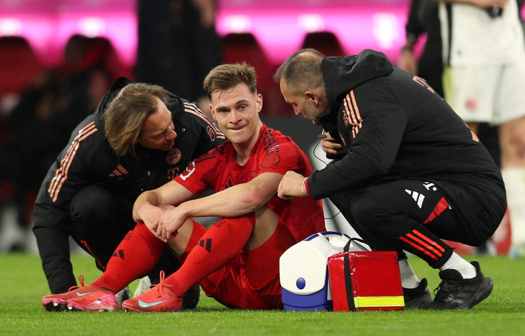 MUNICH, GERMANY - FEBRUARY 23: Joshua Kimmich of Bayern Munich recieves treatment from the physio after sustaining an injury during the Bundesliga match between FC Bayern München and Eintracht Frankfurt at Allianz Arena on February 23, 2025 in Munich, Germany. (Photo by Leonhard Simon/Getty Images)