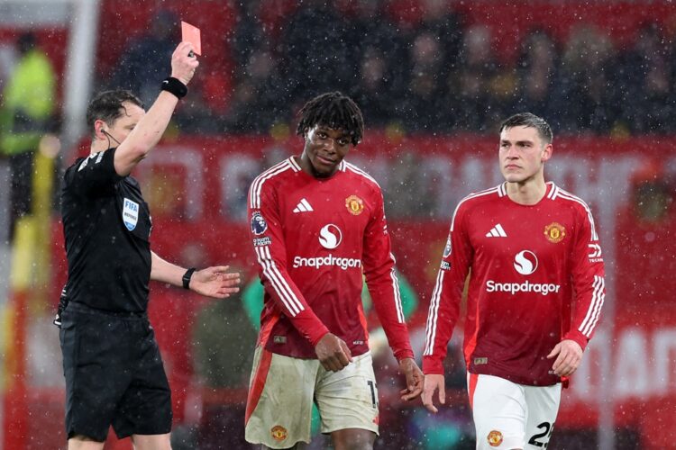 MANCHESTER, ENGLAND: Referee Darren England shows a red card to Patrick Chinazaekpere Dorgu of Manchester United following a VAR review during the ...