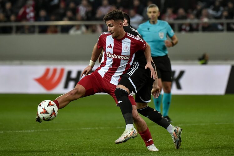 PIRAEUS, GREECE: Charalampos Kostoulas of Olympiacos FC is challenged by Marko Jankovi of Qarabag FK during the UEFA Europa League 2024/25 League P...