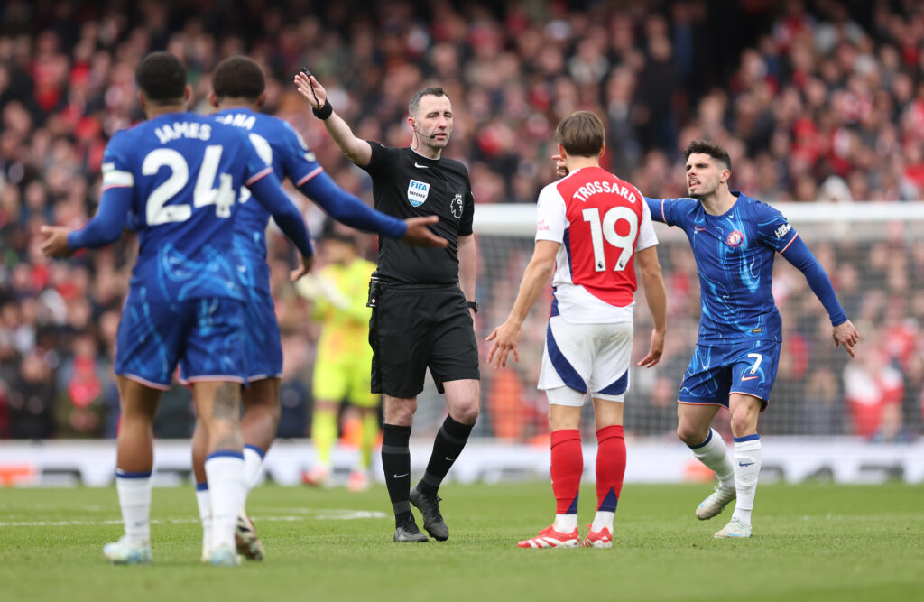 Premier League referees earning up to £250,000 annually 2 LONDON, ENGLAND - MARCH 16: Match Referee Chris Kavanagh gestures as Pedro Neto of Chelsea and Leandro Trossard of Arsenal react during the Premier League match between Arsenal FC and Chelsea FC at Emirates Stadium on March 16, 2025 in London, England. (Photo by Julian Finney/Getty Images)