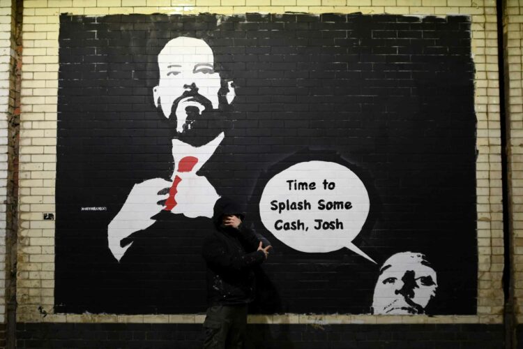 LONDON, ENGLAND - JANUARY 22: A general view as artist North Banksy paints a mural art piece featuring Josh Kroenke, Co-Chairman of Arsenal, which ...