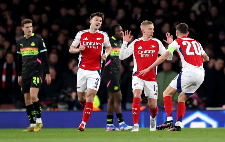 LONDON, ENGLAND - MARCH 12: Oleksandr Zinchenko of Arsenal holds his hands up as he celebrates scoring his team's first goal with teammates Kieran ...