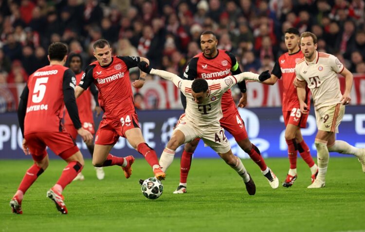 MUNICH, GERMANY: Jamal Musiala of Bayern Munich (R) is challenged by Granit Xhaka of Bayer 04 Leverkusen during the UEFA Champions League 2024/25 R...