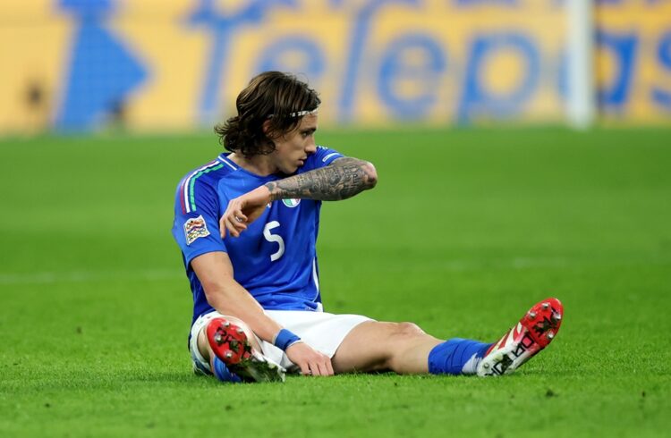 MILAN, ITALY: Riccardo Calafiori of Italy goes down with an injury during the UEFA Nations League quarterfinal leg one match between Italy and Germ...