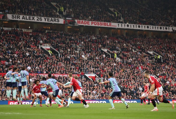 MANCHESTER, ENGLAND: Bruno Fernandes of Manchester United scores his team's first goal from a free kick during the Premier League match between Man...