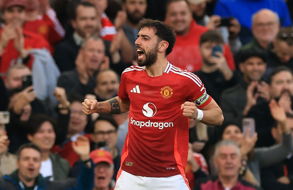 MANCHESTER, ENGLAND: Bruno Fernandes of Manchester United celebrates scoring his team's first goal from a free kickduring the Premier League match between Manchester United FC and Arsenal FC at Old Trafford on March 09, 2025. (Photo by Carl Recine/Getty Images)