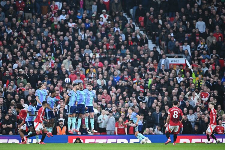 MANCHESTER, ENGLAND: Bruno Fernandes of Manchester United scores his team's first goal from a free kick during the Premier League match between Man...