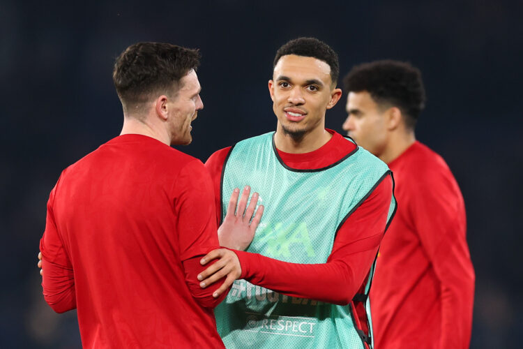 PARIS, FRANCE - MARCH 05: Trent Alexander-Arnold of Liverpool (R) speaks with teammate Andrew Robertson in the warm-up prior to the UEFA Champions ...