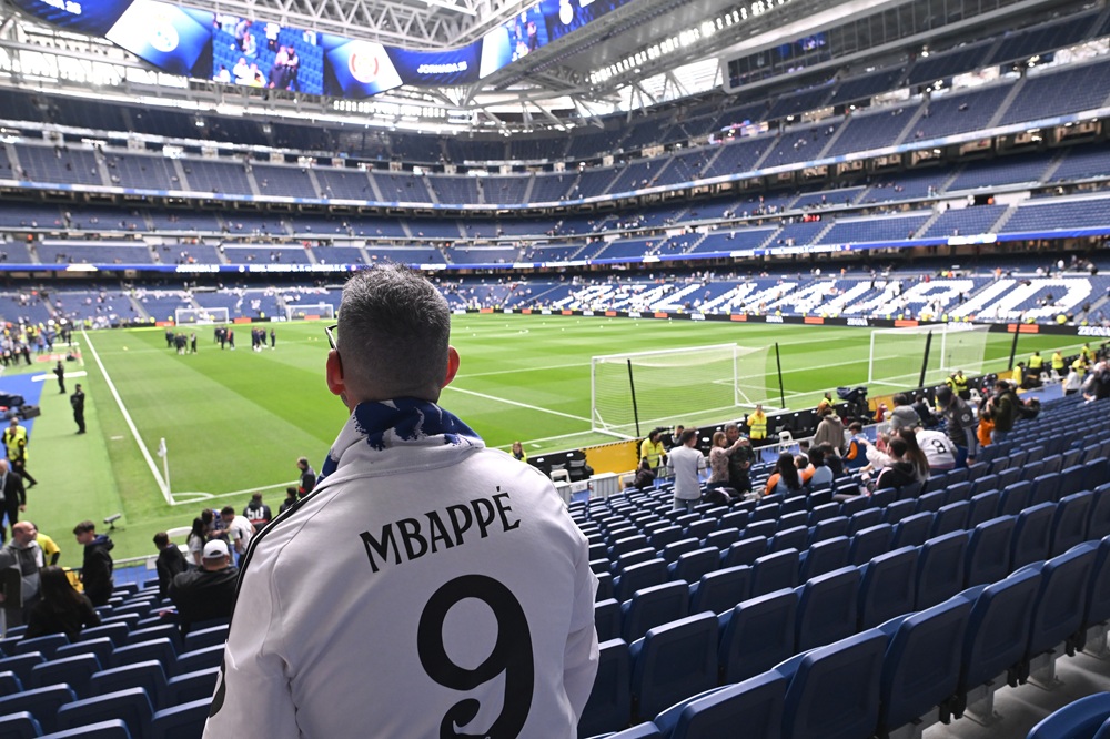 UEFA to discuss Champions League change amid Arsenal fixture criticism 2 MADRID, SPAIN: A general view inside the stadium as fan of Real Madrid watches on whilst wearing a Kylian Mbappe match shirt prior to the LaLiga match between Real Madrid CF and Girona FC at Estadio Santiago Bernabeu on February 23, 2025. (Photo by Denis Doyle/Getty Images)